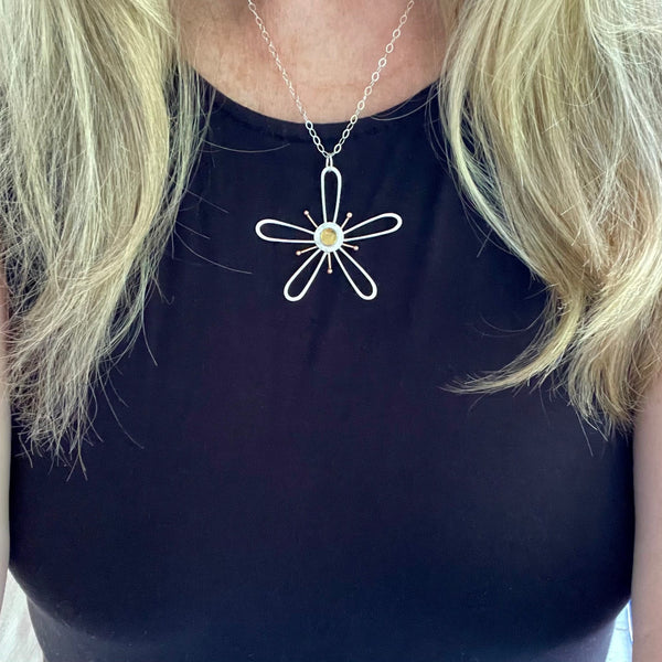 Flower necklace worn with black shirt