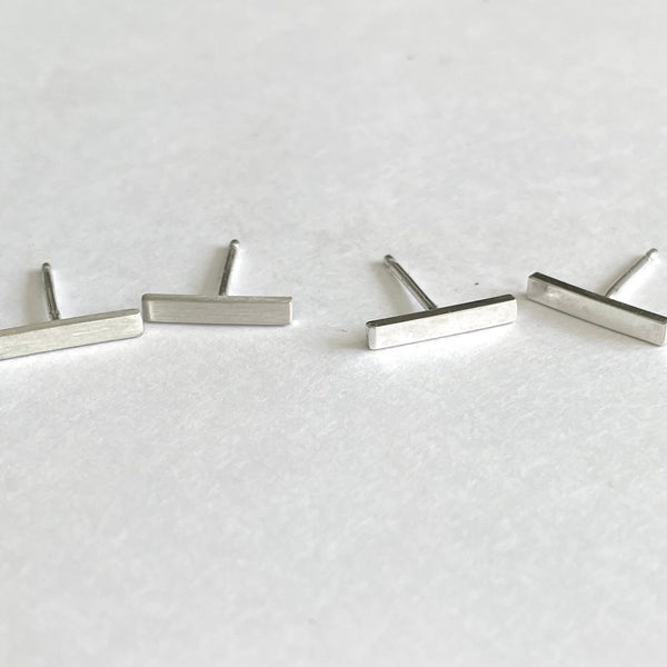 1/2" silver bar earrings shown in matte on the left and shiny on the right