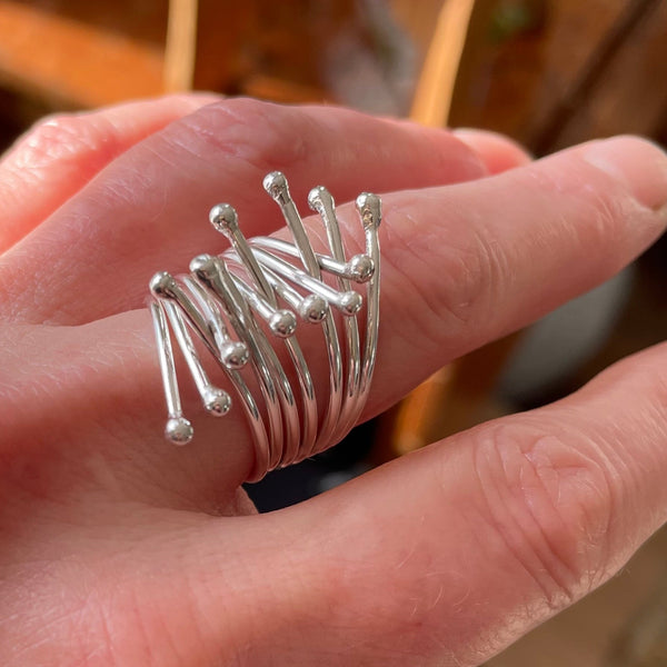 Embrace ring in silver shown on finger