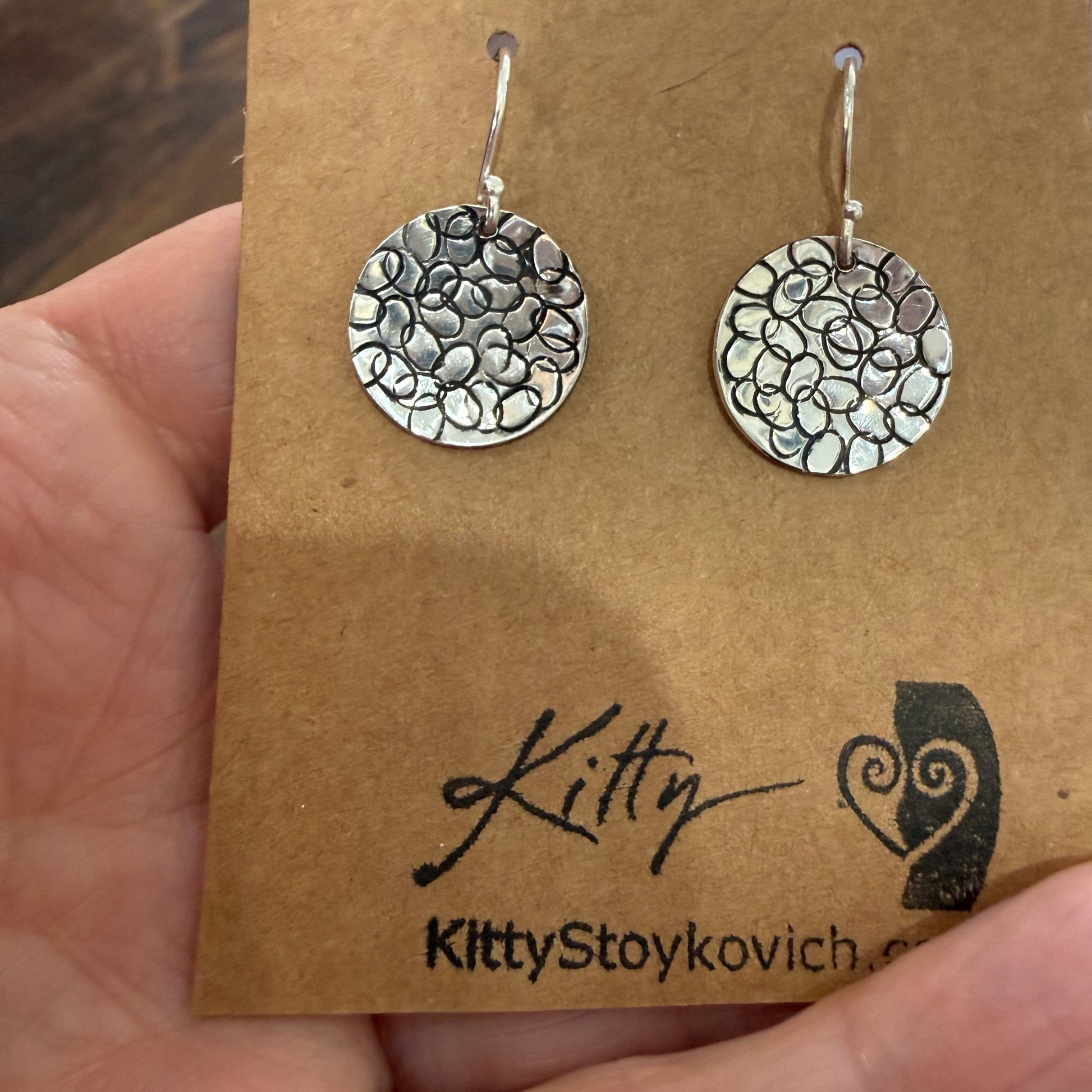Circle with Dots Design Earrings in Sterling Silver on earring card