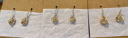 Small and Medium size gold fill knot earrings shown on cands