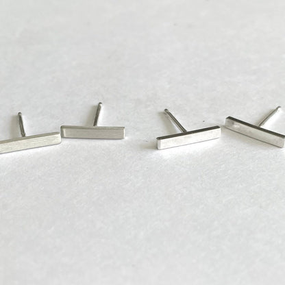 1/2" silver bar earrings shown in matte on the left and shiny on the right