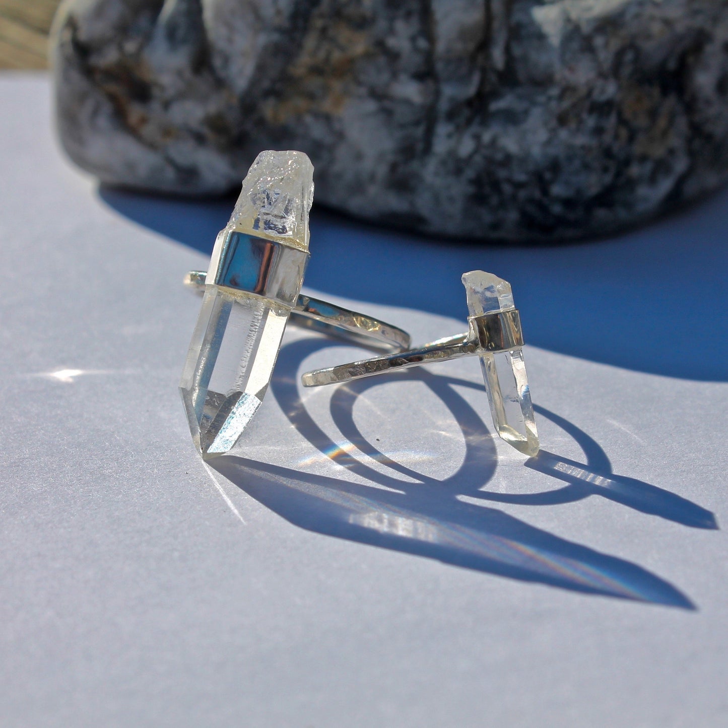 Large crystal ring next to small crystal ring for size comparison