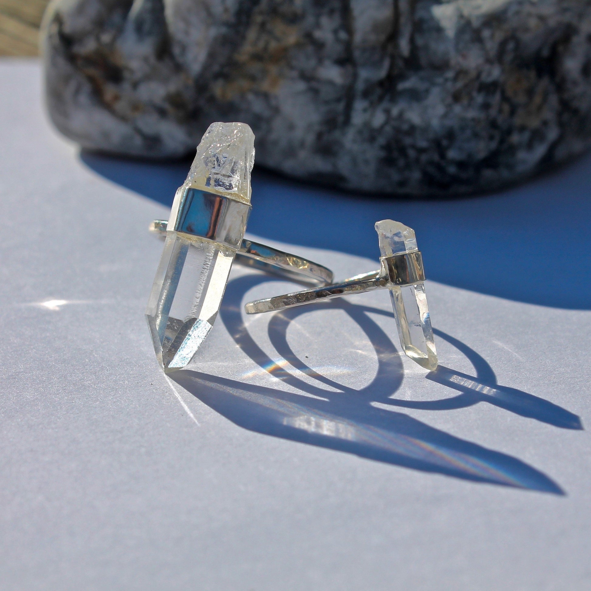 Large crystal ring next to small crystal ring for size comparison