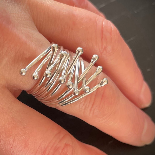 Embrace ring in silver shown on finger