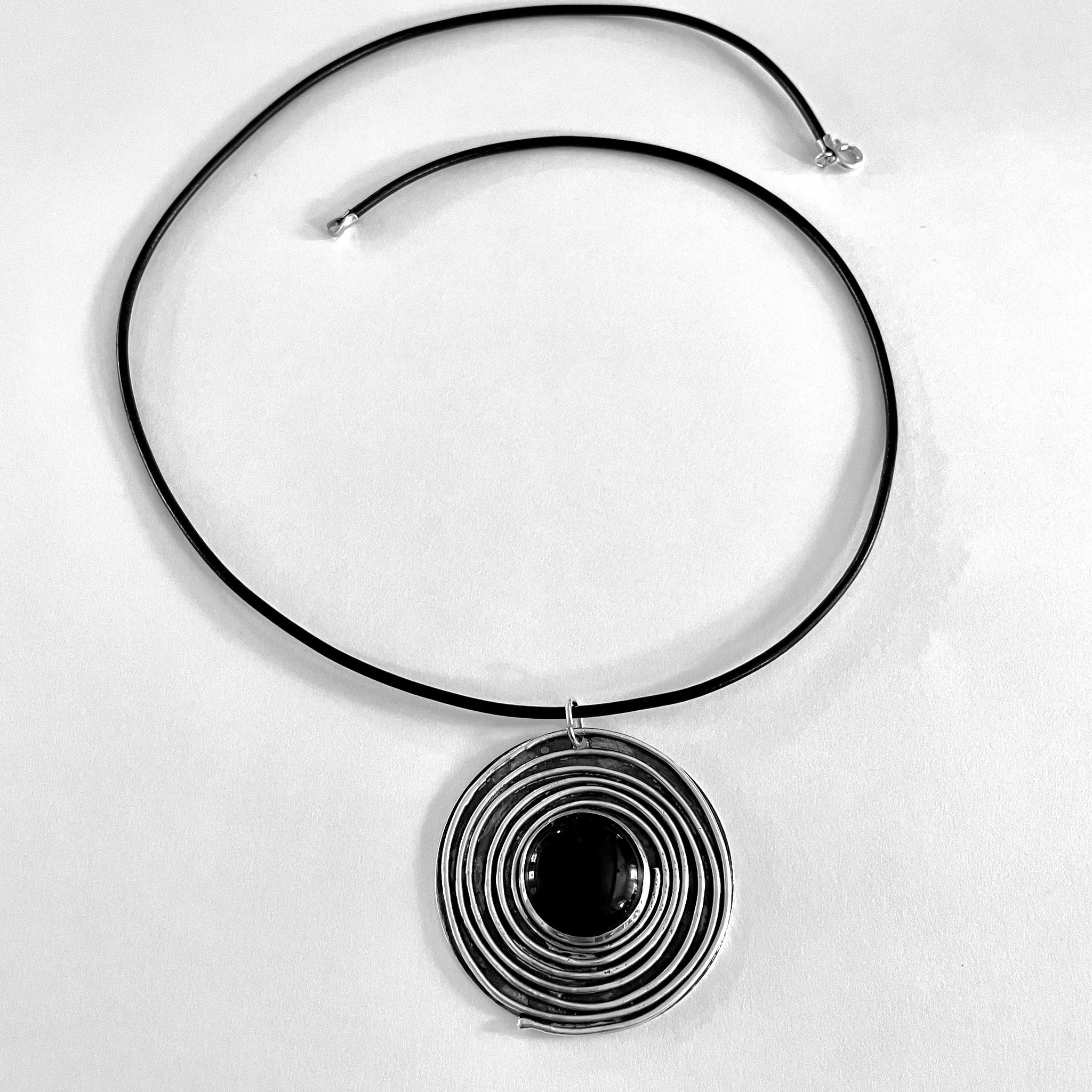 Large Onyx necklace on black leather laying on white background 