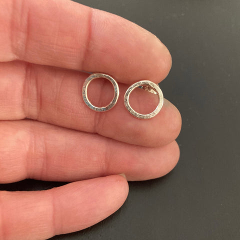Small Silver Circle Post earrings shown in hand