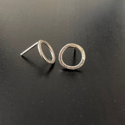 Small Silver Circle Post earrings shown on black background