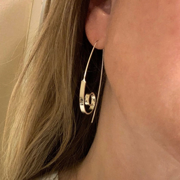 Large swirl earrings on model