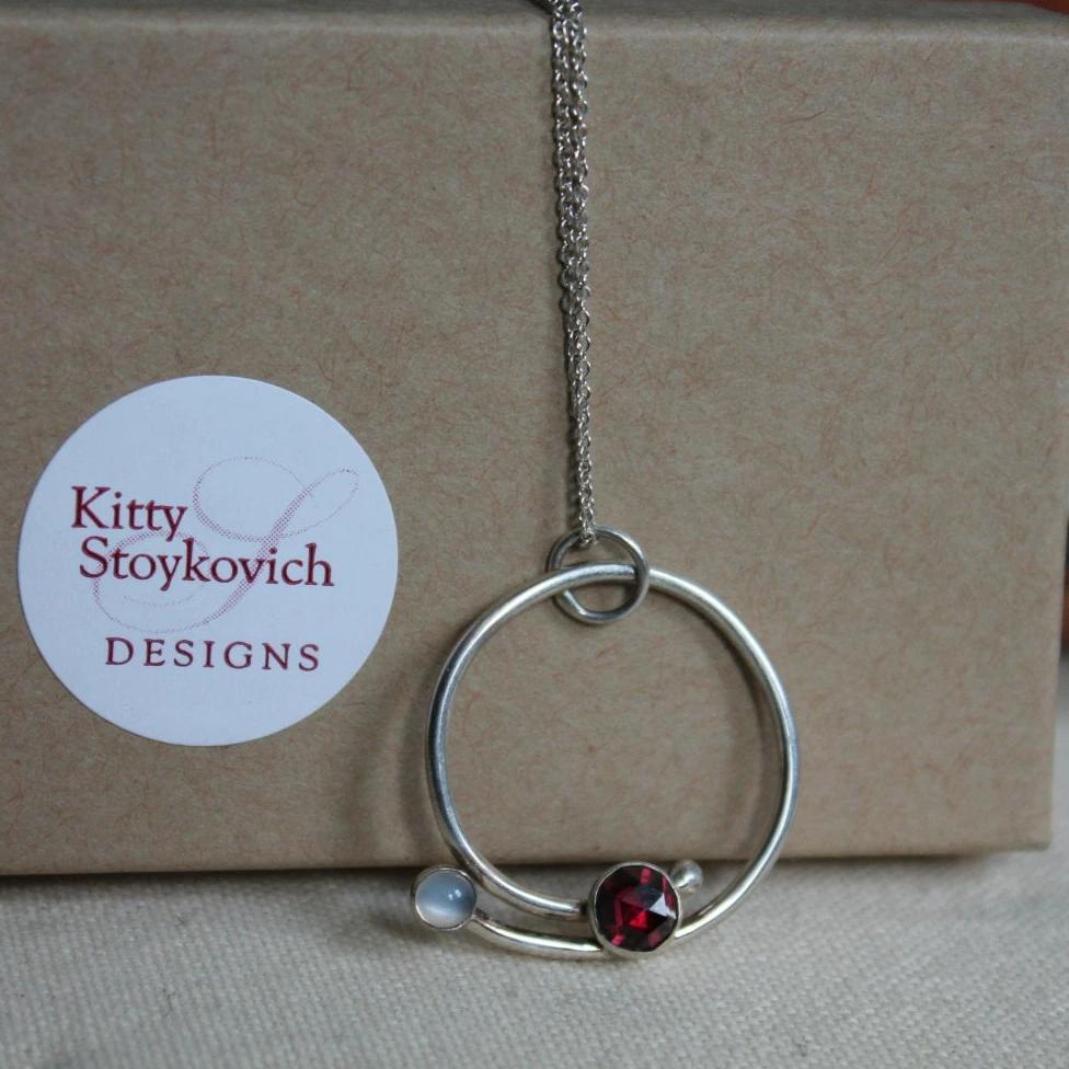 Circle with Rose Cut Garnet and Moonstone Pendant in Silver