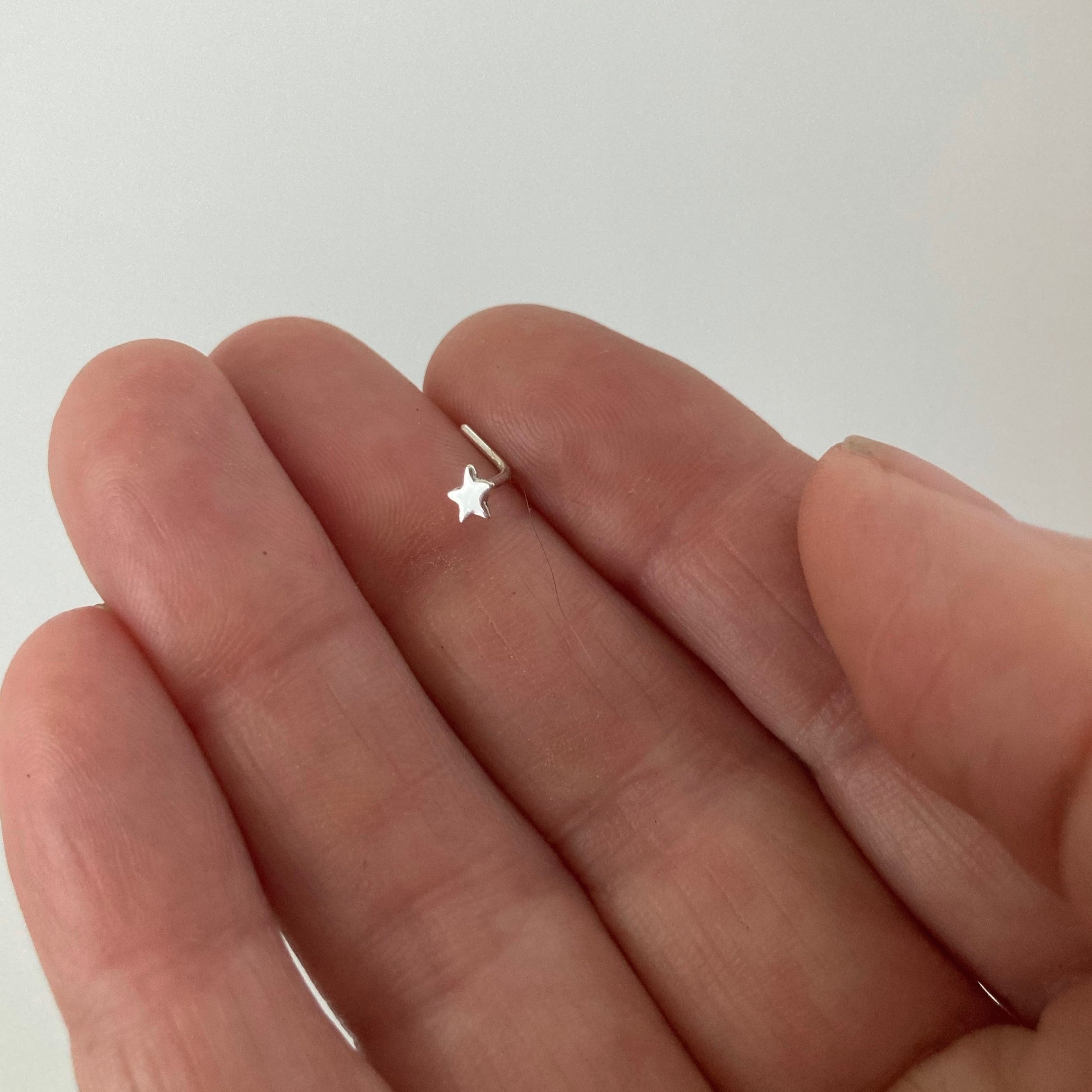Star Nose Ring in Sterling Silver shown on hand showing the bent post