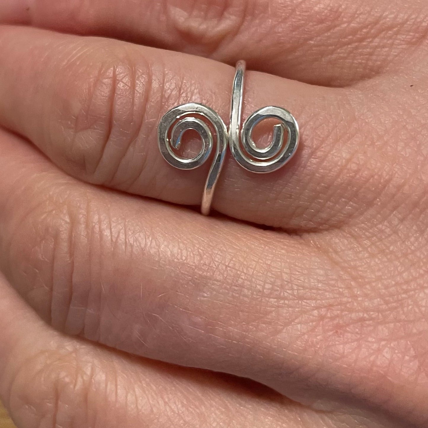 Double Swirl ring on finger