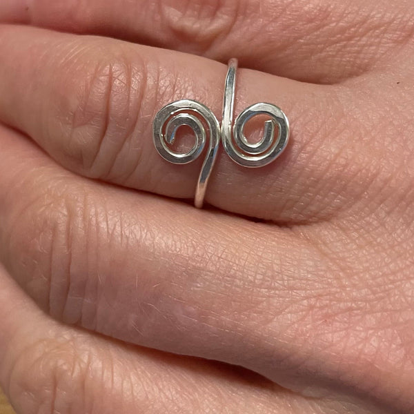Double Swirl ring on finger