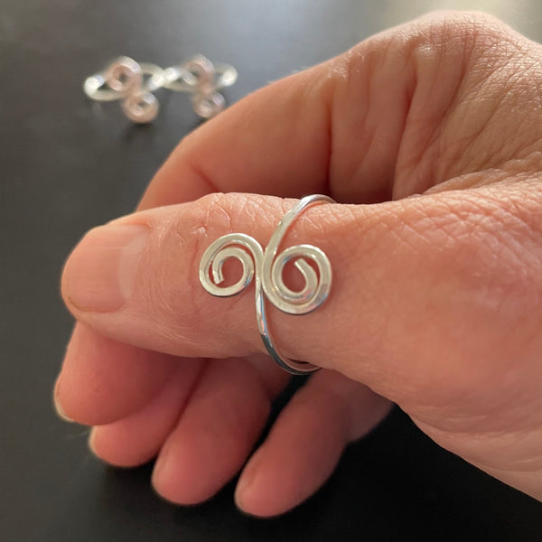 Double Swirl ring on thumb
